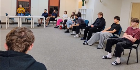 Powiększ grafikę: Młodzież siedząca na krzesłach słuchająca wykładu